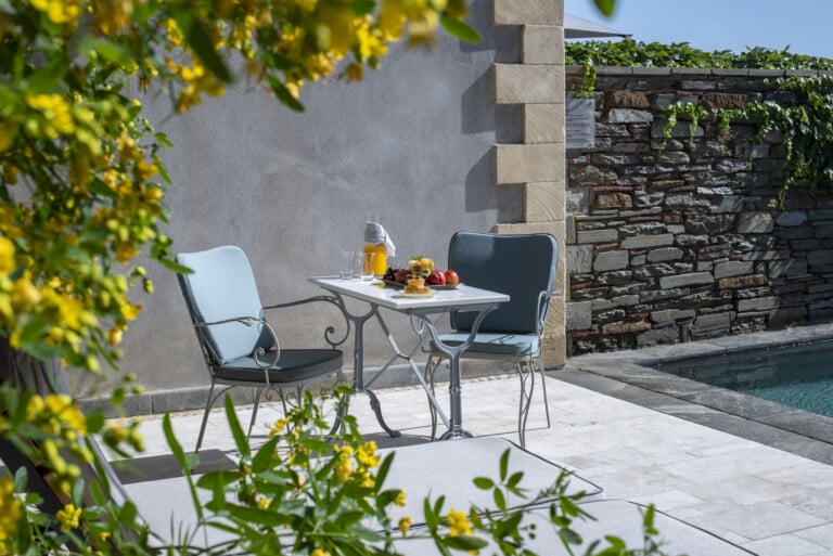 Table and chairs with fresh fruit at the pool terrace of Kinsterna Pool Villa, the place to harbour your Peloponnese honeymoon in Greece